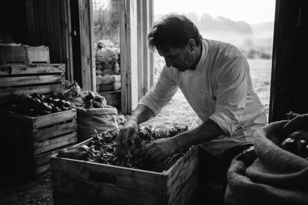 Chef inspecting fresh local produce for ingredient transparency at Hudson Valley restaurant