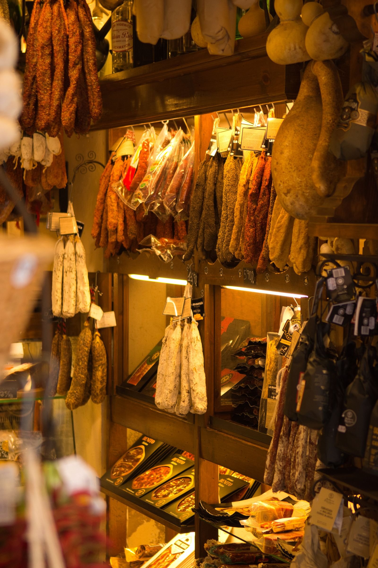 Artisan charcuterie curing room with hanging meats that shows how time and controlled drying shape texture.