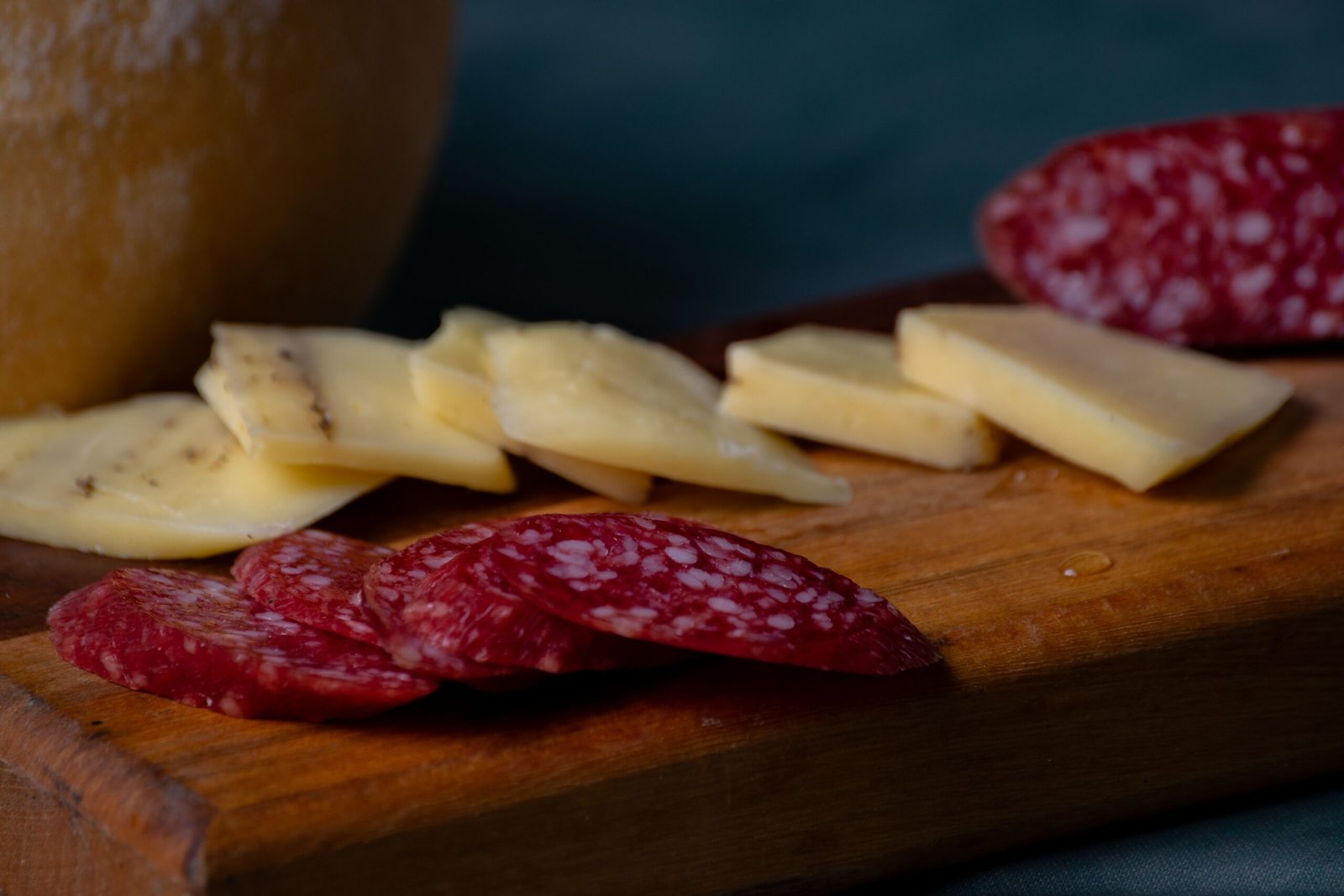 Close-up of sliced artisan charcuterie showing the dense cut surface and texture of dry-cured salami.